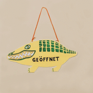 Animation eines stilisierten Krokodils aus Pappe als Ladenschild zum Wenden, beschriftet mit "offen" und "insolvent"